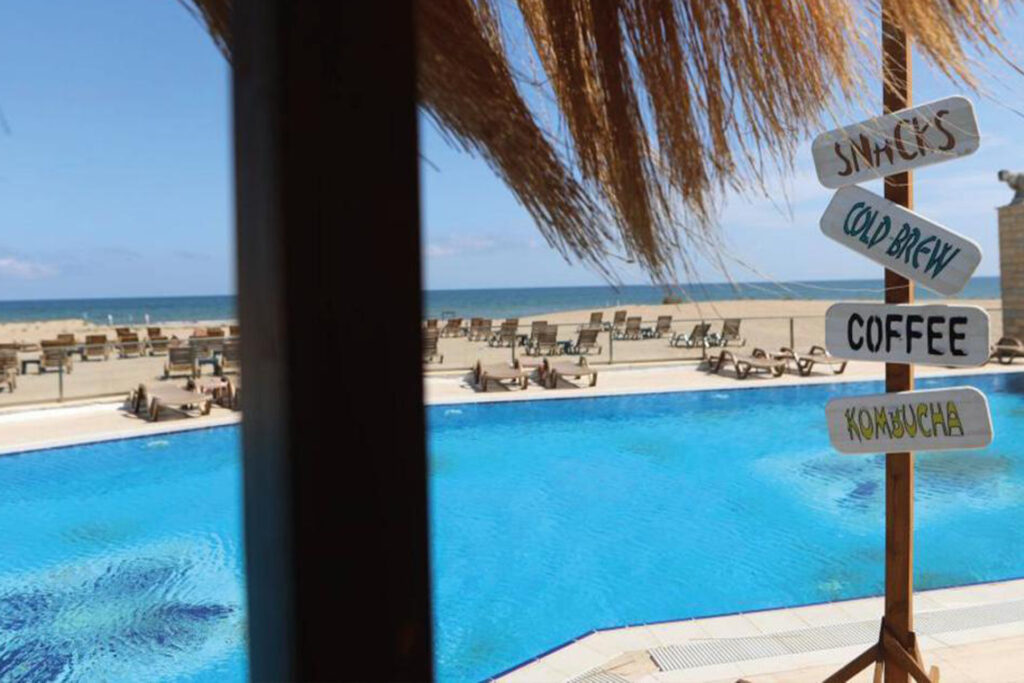 Close-up of a pristine pool on Sile Beach, surrounded by palm trees and offering a view of the sandy shoreline.