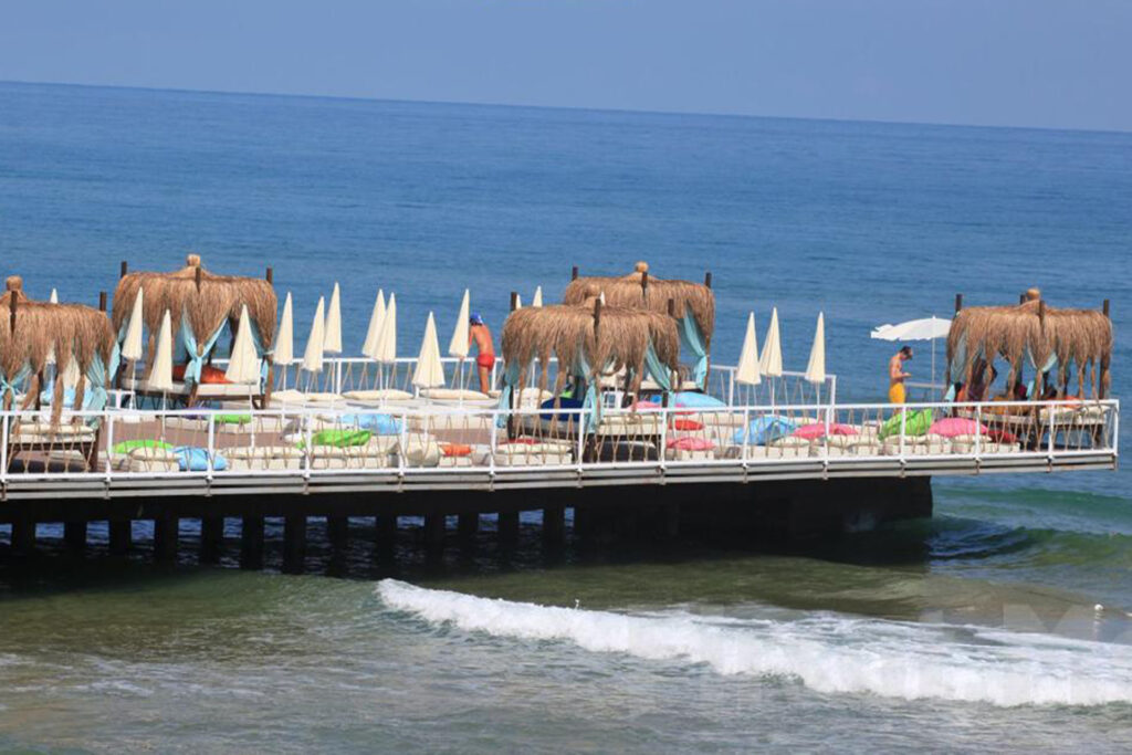 Sunny day at Solar Beach with people lounging on sunbeds by the Black Sea