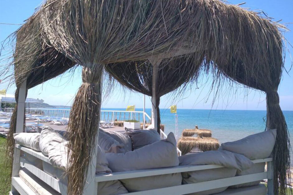 Relaxing scene of sunbeds lined up along the shore at Solar Beach.