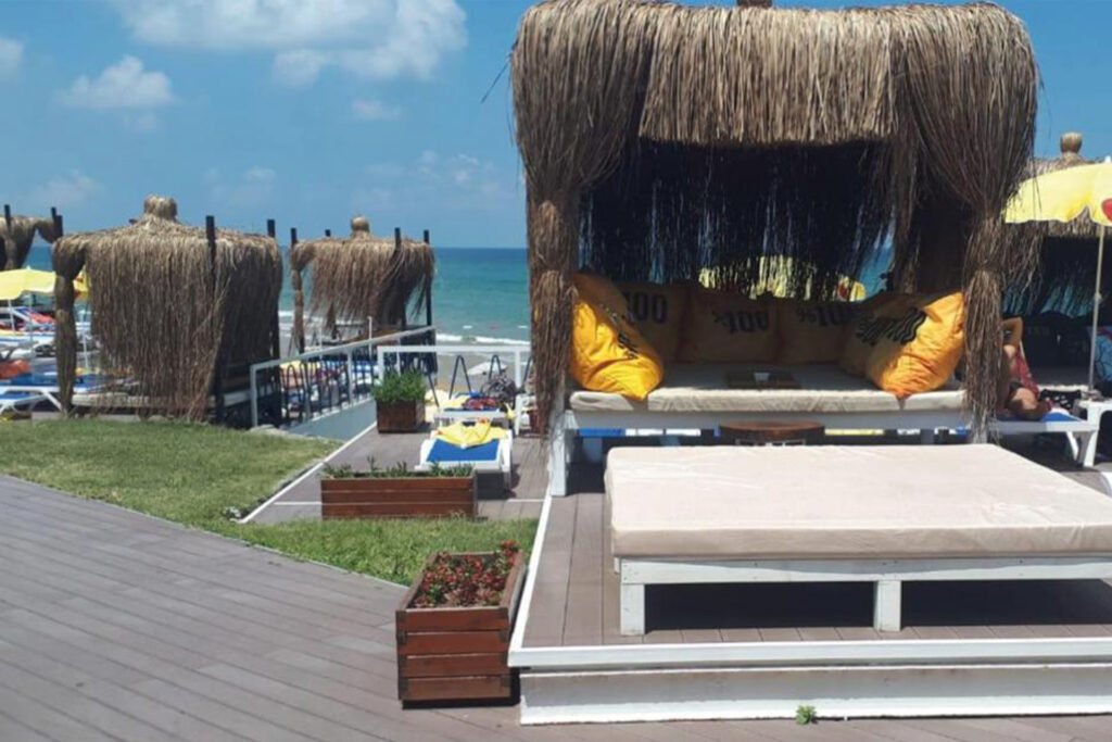 Relaxing scene of sunbeds lined up along the shore at Solar Beach.