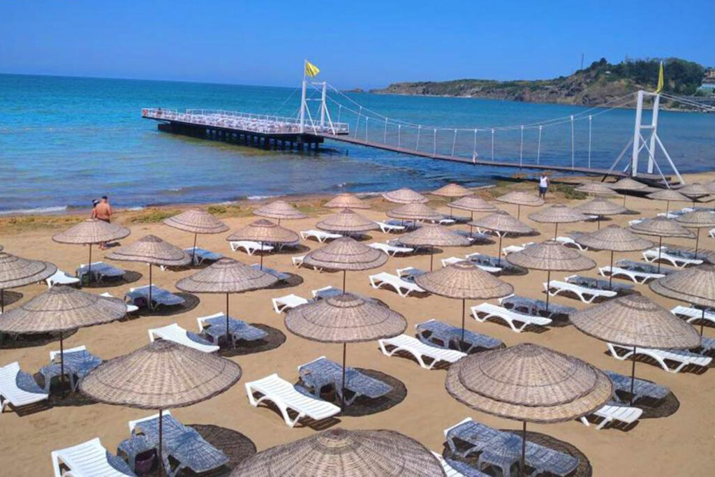 Relaxing scene of sunbeds lined up along the shore at Solar Beach.