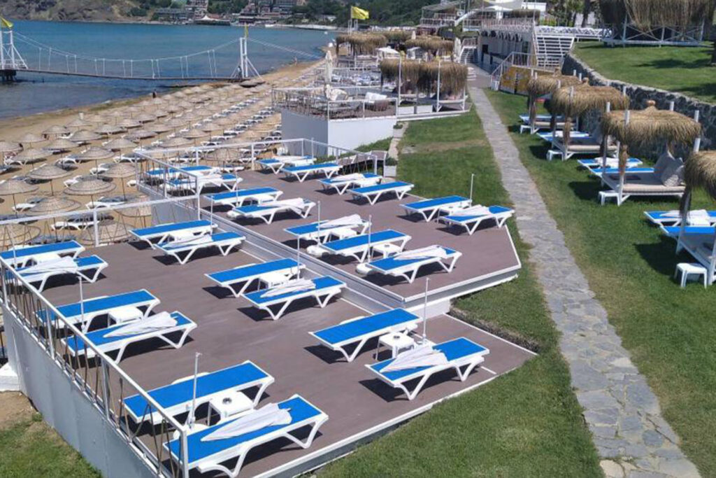 Relaxing scene of sunbeds lined up along the shore at Solar Beach.